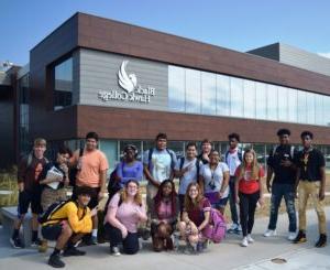 students pose in front of the Building 1 addition